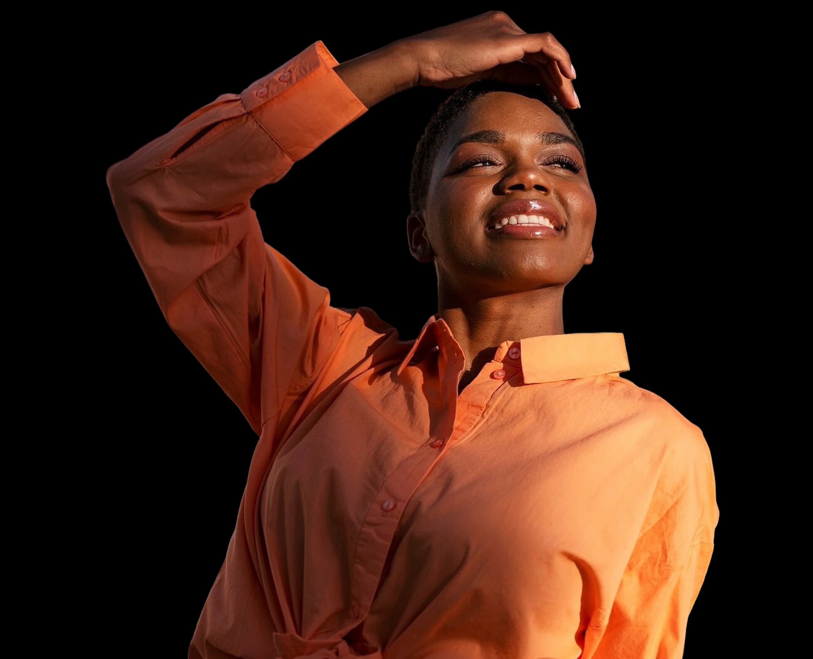 Smiling woman with one hand on her head